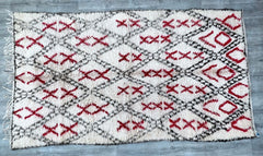 Transform your home with this gorgeous vintage Berber rug, a masterpiece of Moroccan weaving traditions. Handmade from natural wool, this 5x9 ft rug features a soft, high-pile texture and a captivating blend of neutral and faded colors, creating a warm, inviting atmosphere. The intricate diamond and tribal patterns add depth and movement, making it a focal point in any space. Ideal for layering or standalone use, this rug complements Scandinavian, bohemian, and eclectic styles. Each piece is one-of-a-kind,