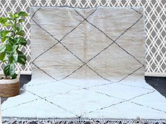 Enhance your décor with this luxury Beni Ourain wool rug, a handcrafted masterpiece that blends bohemian style with vintage Moroccan charm. Made from premium natural wool, this Berber tribal carpet offers unmatched softness and durability. The minimalist yet intricate patterns create a neutral yet striking focal point, ideal for Scandinavian, boho, or eclectic interiors. Whether placed in a living room, bedroom, or entryway, this handwoven Moroccan area rug adds warmth and texture while maintaining its auth