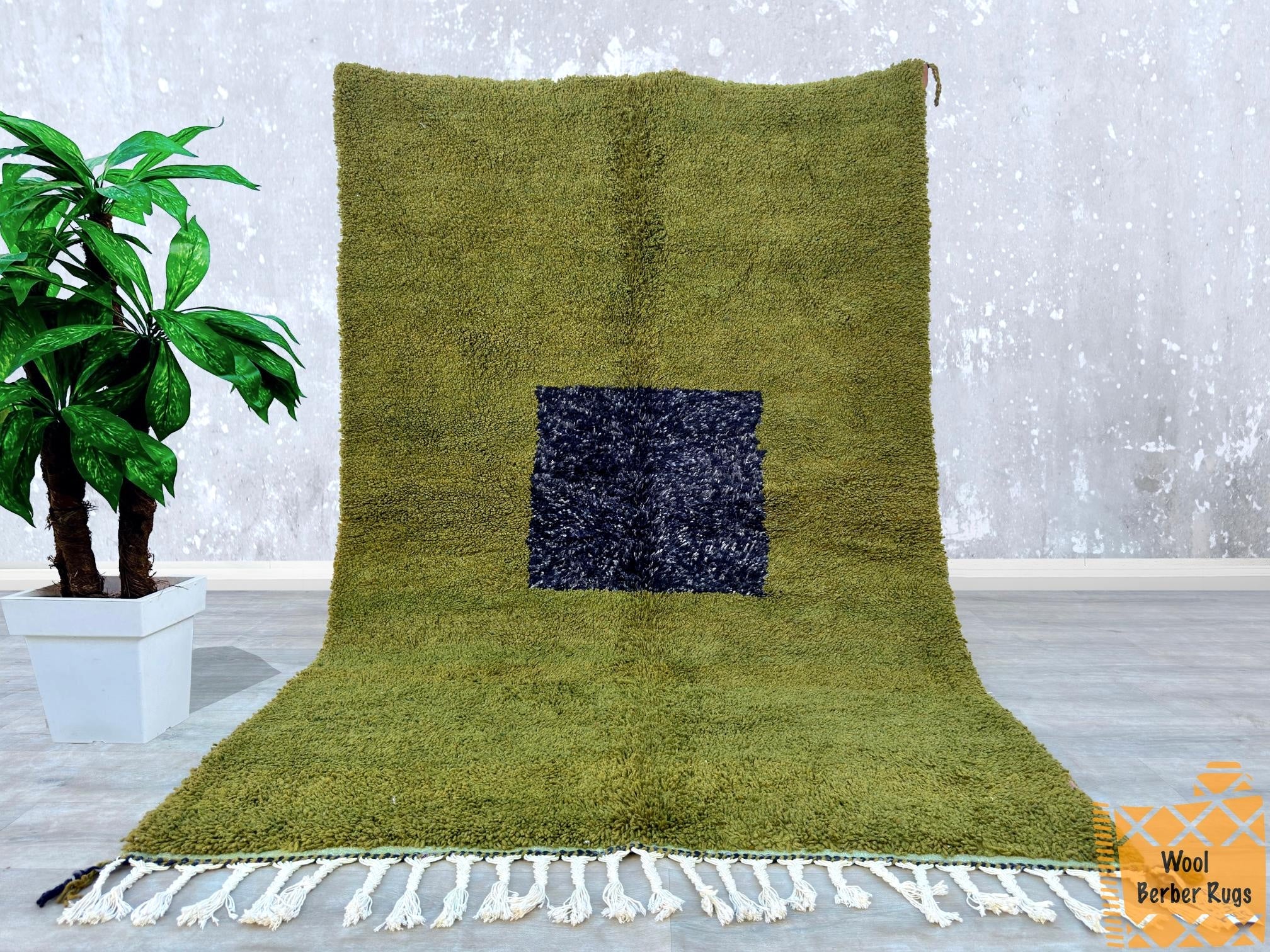 Bring timeless charm into your home with this luxurious green Moroccan rug, meticulously handwoven by traditional artisans. The rich olive hue and intricate abstract patterns create a striking focal point in any room. Made from ultra-soft natural wool, this durable yet plush carpet is ideal for high-traffic areas while maintaining its beauty. A perfect blend of bohemian flair and contemporary design, this Berber rug is a must-have for those who appreciate artisan craftsmanship and unique decor.