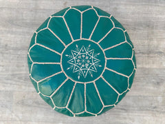 Discover premium leather ottomans that combine sophistication and practicality. From tufted square designs to round poufs, our collection includes genuine leather, faux leather, and bonded leather options. Use as a footrest, storage bench, or coffee table with a reversible tray lid. Features like lift-top storage, sturdy wood legs, and eco-friendly fillings make these ottomans perfect for small spaces. Choose modern mid-century styles or Moroccan-inspired hand-stitched pieces in neutral tones (black, beige,