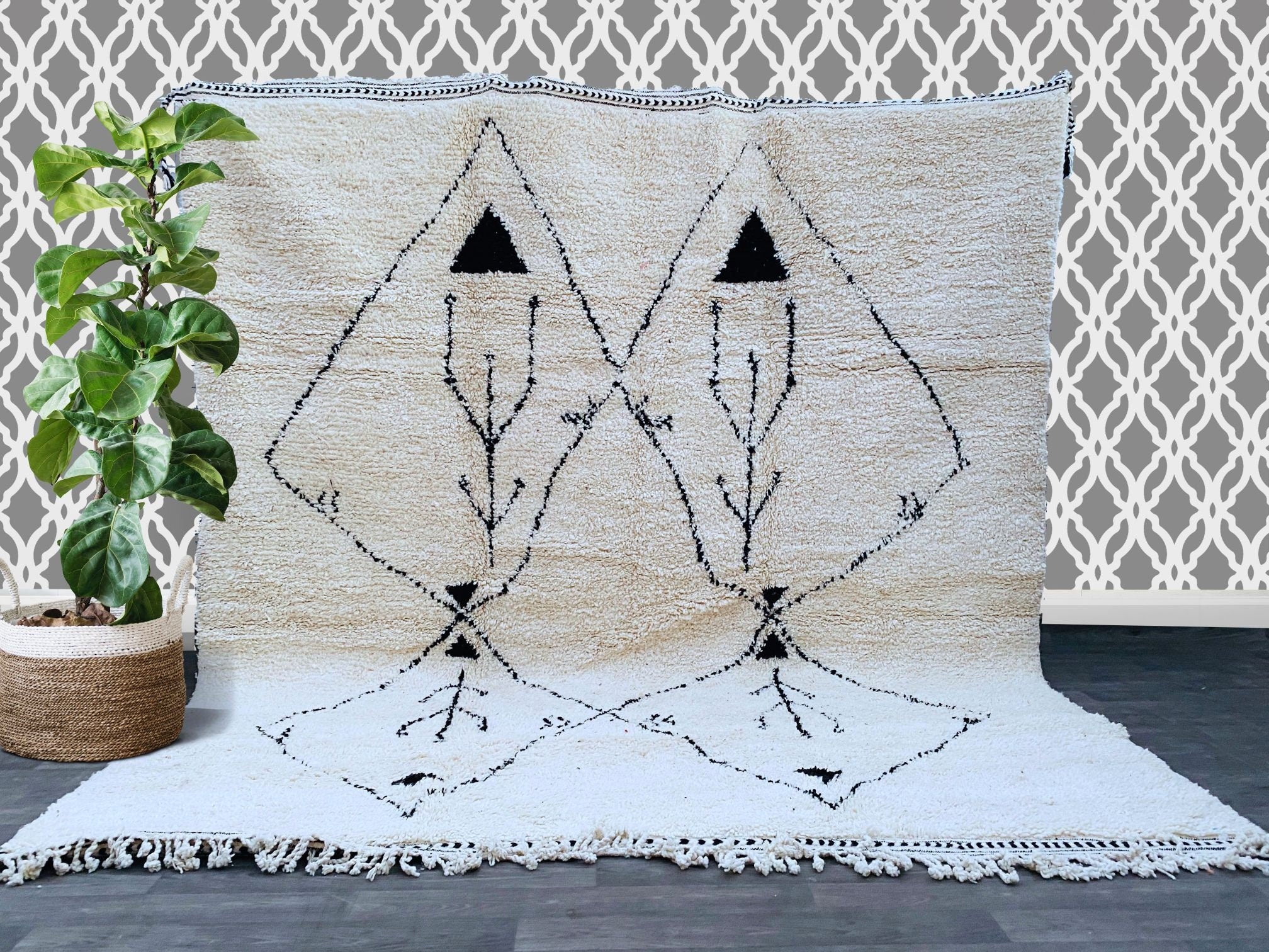 Discover the beauty of a handwoven Moroccan rug, made from 100% natural wool for a plush, cozy feel underfoot. This Berber carpet showcases intricate geometric patterns and a soft, textured finish, ideal for living rooms, bedrooms, or dining areas. The fair trade craftsmanship ensures ethical production, supporting artisan communities. With its neutral black and white tones, this boho-chic area rug effortlessly complements any décor style. Choose a custom design or a classic Beni Ourain-inspired piece for a