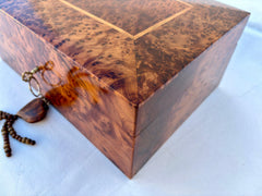 Bring a touch of artisanal craftsmanship into your home with this stunning Moroccan-inspired wooden jewelry box. Expertly carved from premium burl wood, this decorative storage box features a smooth, polished surface and a secure locking mechanism. The spacious interior is lined with soft velvet, protecting delicate jewelry pieces from scratches. Whether used as a jewelry organizer, memory box, or decorative accent, this handcrafted wooden chest makes a perfect gift for weddings, anniversaries, or special o