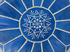 Bring global flair to your home with hand-embroidered Moroccan leather pouffes. Made in Marrakech using vegetable-tanned goat leather, these poufs feature geometric patterns and double-zippered seams for longevity. Lightweight yet sturdy, they work as floor seats, footstools, or decorative accents. Opt for unfilled poufs to customize stuffing (recycled foam, cotton) or pre-filled options for instant comfort. Free shipping worldwide on classic round, square, or oversized designs. A sustainable choice—each pi
