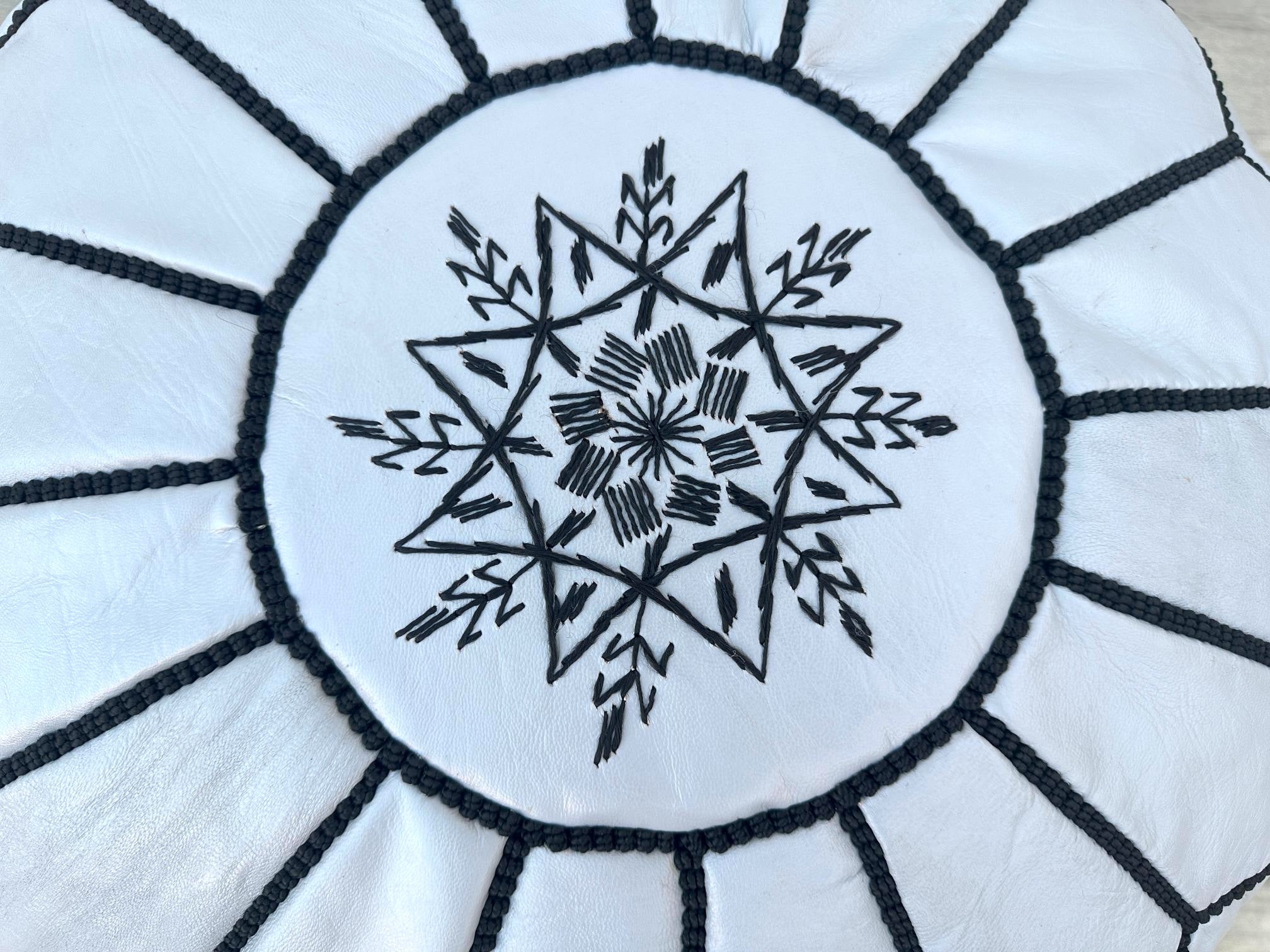 Bring global-inspired elegance into your home with Moroccan leather poufs, crafted using traditional tanning and embroidery techniques. These hand-stitched leather ottomans are made from vegetable-tanned goat leather, ensuring a natural, eco-friendly finish. Perfect for boho, eclectic, or modern interiors, they function as footrests, side tables, or extra seating. Available in unstuffed pouf covers or pre-filled options, our Moroccan leather footstools feature geometric patterns and rich hues. Pair them wit