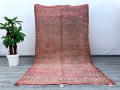 Enhance your décor with this vintage pink Moroccan rug, a beautiful handwoven Beni Mguild carpet featuring rich textures and faded hues. Each piece tells a story through its tribal motifs and artisanal craftsmanship, making it a perfect addition to bohemian, mid-century, or minimalist interiors. Made from natural wool, this rug is soft underfoot while maintaining durability for high-traffic areas. Whether placed in a bedroom, lounge, or entryway, its warm, earthy tones create a cozy and inviting atmosphere,