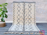 Enhance your décor with a premium handmade Moroccan Berber rug, featuring a classic tribal black-and-white pattern. Woven from 100% natural wool, this luxurious shag rug offers ultra-soft comfort underfoot while maintaining durability for high-traffic areas. The neutral tones and geometric motifs make it versatile for Scandinavian, bohemian, or contemporary interiors. Whether placed in a living room, bedroom, or entryway, this Moroccan wool rug brings a touch of global craftsmanship and organic texture to y