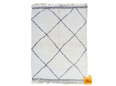 Enhance your space with a soft, cozy Berber wool rug, meticulously handmade by Moroccan artisans. This tribal-inspired carpet features a plush, high-pile texture in creamy ivory with subtle black geometric patterns, adding warmth and sophistication to any room. The natural wool fibers provide durability and a luxuriously soft feel, making it perfect for barefoot comfort. Whether placed in a boho-chic living room, minimalist bedroom, or nursery, this versatile rug brings a touch of global craftsmanship and o