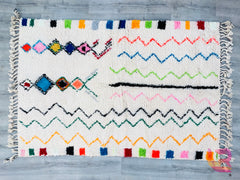 Bring authentic Moroccan charm into your home with this exquisite vintage Azilal rug, handwoven by skilled Berber artisans. Featuring intricate geometric patterns and a soft, neutral color palette, this 5x8ft wool rug adds warmth and texture to any space. The traditional Berber designs tell a story of heritage, making it a unique centerpiece for living rooms, bedrooms, or boho-inspired interiors. Crafted from natural wool, this rug is durable, cozy, and full of character. Whether layered over hardwood floor