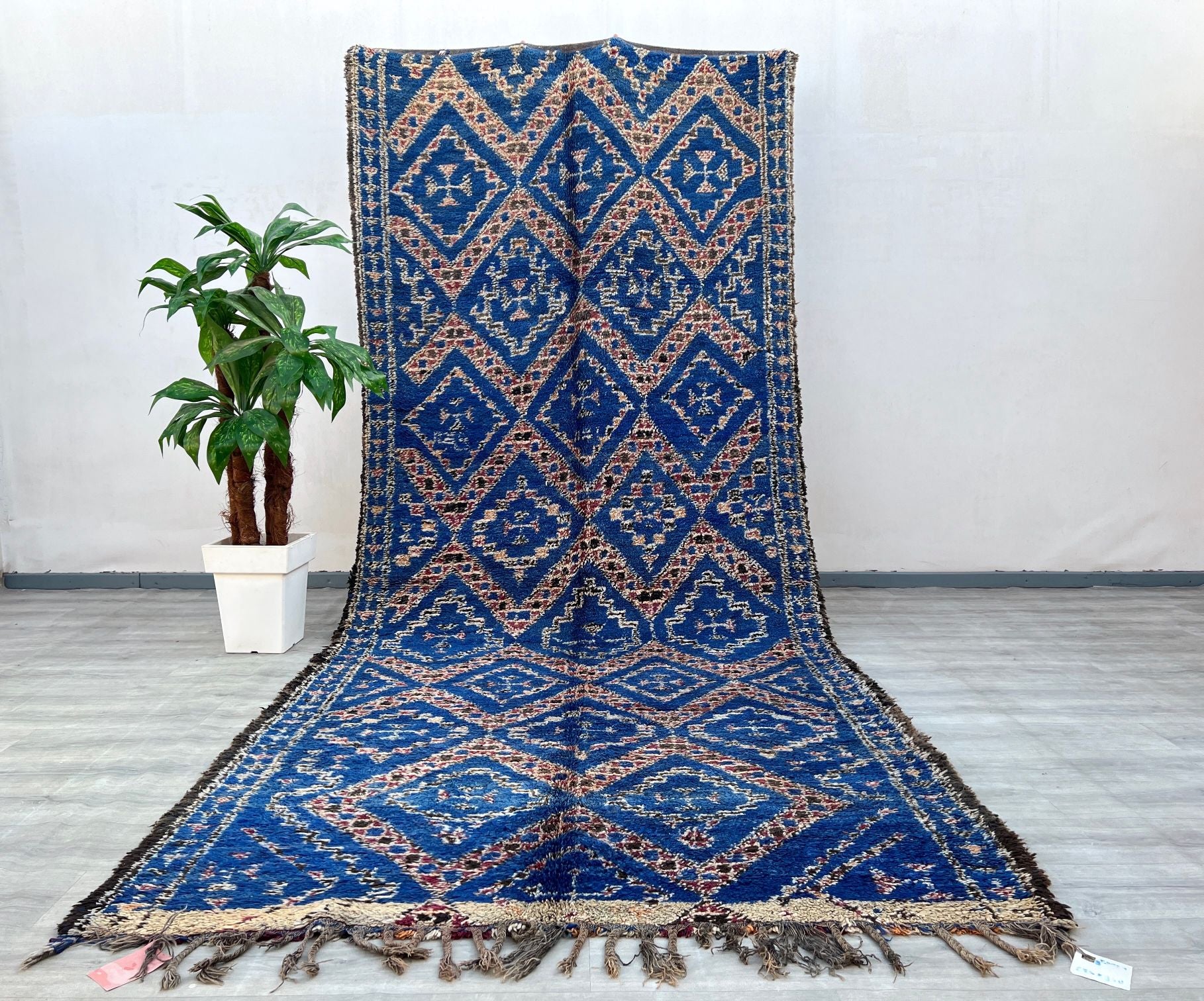 This exquisite vintage Moroccan Boujad rug is a stunning example of traditional Berber craftsmanship. Handwoven by skilled artisans, this 6x13 ft rug features authentic tribal patterns in rich, earthy tones, blending rustic charm with bohemian elegance. Made from 100% natural wool, it offers durability and a plush texture, perfect for adding warmth to living rooms, bedrooms, or dining spaces. The faded vintage hues and geometric motifs reflect the cultural heritage of Morocco’s Boujad region, making it a un
