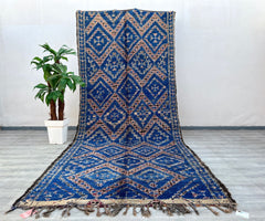 This exquisite vintage Moroccan Boujad rug is a stunning example of traditional Berber craftsmanship. Handwoven by skilled artisans, this 6x13 ft rug features authentic tribal patterns in rich, earthy tones, blending rustic charm with bohemian elegance. Made from 100% natural wool, it offers durability and a plush texture, perfect for adding warmth to living rooms, bedrooms, or dining spaces. The faded vintage hues and geometric motifs reflect the cultural heritage of Morocco’s Boujad region, making it a un