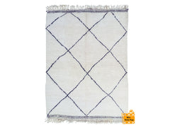 Elevate your home decor with this handmade Beni Ourain-style rug, inspired by the rich heritage of Moroccan Berber tribes. Woven from premium natural wool, this rug features a plush, high-pile texture and striking black-and-white tribal patterns. Ideal for contemporary or eclectic interiors, it effortlessly enhances living rooms, dining spaces, or bedrooms. The neutral tones make it versatile, while the artisanal craftsmanship ensures a one-of-a-kind piece. Whether you prefer a vintage, bohemian, or modern