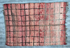 Discover the allure of this Tribal Berber Carpet, a handmade Moroccan rug that exudes rustic elegance and cultural heritage. Woven with premium wool, this vintage Boujad Kilim rug features intricate patterns and a soft, textured feel. Its earthy red tones and traditional motifs make it a versatile choice for boho home decor, blending seamlessly with modern and eclectic styles. Whether layered in a living room or used as a woven wool runner, this authentic Berber rug brings warmth and artisanal charm to any