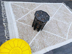 Discover the charm of Moroccan craftsmanship with this vintage Azilal Berber rug, a 7x10ft hand-knotted wool carpet featuring vibrant tribal motifs and a distressed, artistic finish. Each rug tells a story through its abstract geometric patterns and rich earthy tones, making it a perfect fit for eclectic, boho, or farmhouse décor. The thick, plush wool offers unmatched comfort, while the handmade imperfections add authenticity. Whether draped over hardwood floors or layered in a cozy bedroom, this Moroccan
