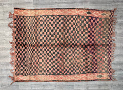 Bring rustic elegance into your home with this vintage checkered runner rug, inspired by traditional Moroccan weaving techniques. The playful pink and brown checkerboard pattern adds a pop of color, while the natural wool material ensures durability and comfort underfoot. Whether used in a hallway, kitchen, or as a bedroom accent, this rug effortlessly blends boho flair with modern simplicity. Its handcrafted imperfections and rich textures make it a standout piece for eclectic and cozy interiors.