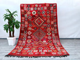 Crafted with care, this 6x10 ft vintage Moroccan rug showcases the finest hand-knotted wool, embodying centuries-old weaving traditions. The Berber tribal motifs, influenced by Boujaad and Azilal heritage, tell a story of nomadic artistry. The natural wool fibers provide softness underfoot while ensuring longevity. Ideal for bohemian, rustic, or modern interiors, this rug blends seamlessly into any décor. Its faded hues and aged texture enhance its antique appeal, making it a sought-after collector’s item.