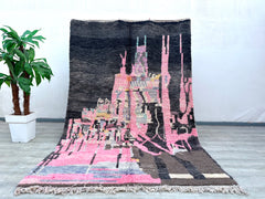 Bring vibrant energy into your home with a vintage Moroccan Azilal rug, handwoven by Berber artisans using premium sheep’s wool. Known for their playful abstract patterns and soft textures, these rugs feature a mix of earthy tones and bold pops of pink, black, and red. Each piece tells a story through its irregular designs, making it a one-of-a-kind addition to bohemian, modern, or eclectic interiors. Whether used as a statement floor piece or a cozy wall hanging, an Azilal rug adds warmth and artistic flai