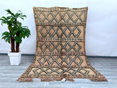 Bring timeless charm to your space with this exquisite vintage Moroccan Berber rug. Handwoven by skilled artisans, this authentic tribal rug features intricate geometric patterns and a rich, natural wool texture. Perfect for adding warmth and character to living rooms, bedrooms, or boho-inspired interiors, this piece showcases traditional craftsmanship with a distressed, vintage appeal. The neutral tones and unique imperfections make it a one-of-a-kind statement piece, blending seamlessly with both modern a