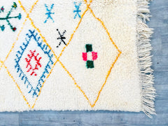 Enhance your space with this handmade vintage Moroccan Berber rug, featuring a minimalist checkered design in soothing neutral tones. Woven from high-quality wool, this rug is plush underfoot while being durable and easy to maintain. Its timeless geometric patterns complement Scandinavian, modern farmhouse, and boho interiors, offering a subtle yet striking focal point. Each rug is individually crafted, ensuring slight variations that highlight its artisanal authenticity. Ideal for layering or as a standalo