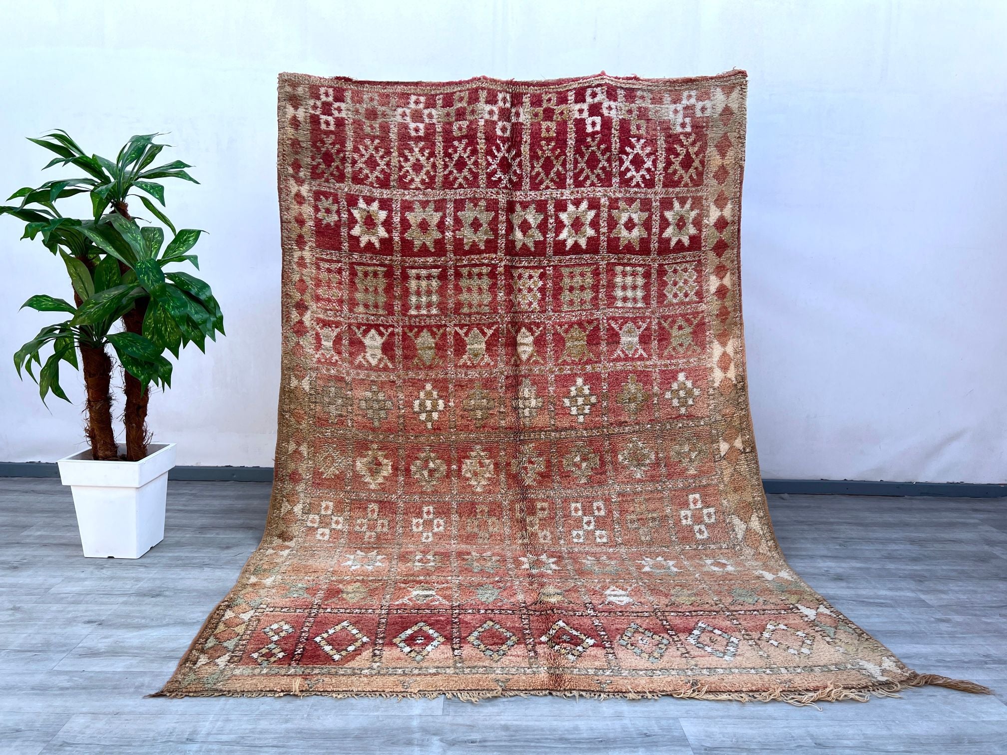 Elevate your interior with this vintage Moroccan Berber rug, a masterpiece of handwoven tribal artistry. Featuring a bold geometric motif and a soft wool texture, this rug reflects the rich cultural heritage of Moroccan craftsmanship. The earth-toned palette and distressed vintage look add character to any room, whether placed in a boho-chic living space, eclectic bedroom, or minimalist dining area. Each rug is unique, showcasing slight variations that highlight its authentic handmade nature. A perfect blen