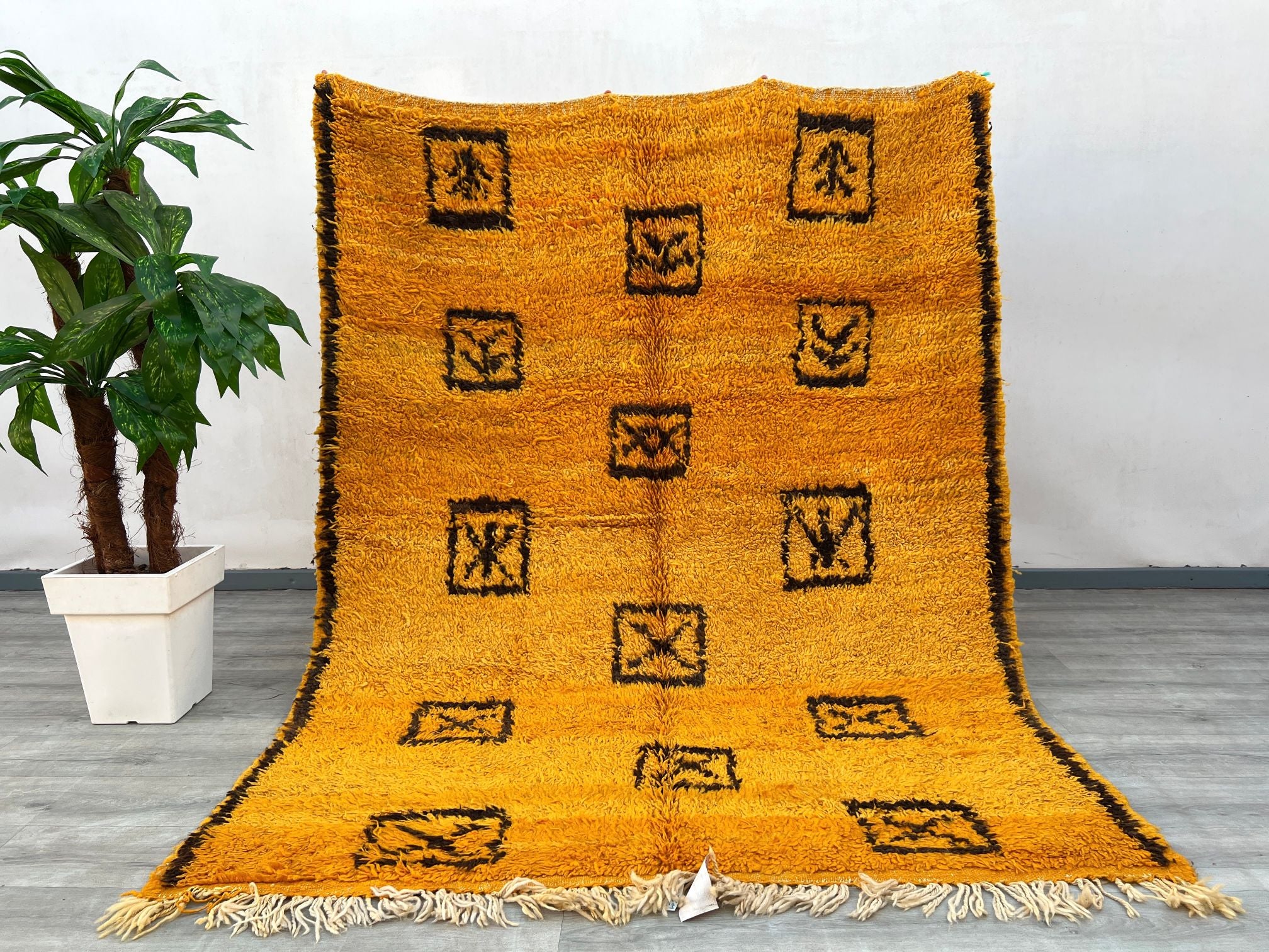 Elevate your space with this authentic handmade Moroccan Beni Ourain rug, crafted by Berber artisans using 100% natural wool. Measuring 5.9 ft x 7.5 ft, this bohemian-style rug features a soft, plush texture with traditional tribal patterns, perfect for adding warmth to living rooms, bedrooms, or cozy reading nooks. The neutral tones blend seamlessly with modern, rustic, or eclectic interiors. Each rug is unique, showcasing slight variations that highlight its artisanal heritage. Ideal for those who appreci
