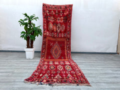 Elevate your home with this authentic Beni Ourain vintage rug, measuring approximately 3.9x12.7 ft. This handwoven Moroccan wool rug boasts a unique blend of Berber tribal patterns and a soft, plush texture, ideal for cozy interiors. The neutral tones and geometric motifs reflect Morocco’s nomadic heritage, while the slightly distressed vintage finish adds character. Perfect for layering in living rooms, bedrooms, or entryways, this large Moroccan area rug is both durable and stylish. Each piece tells a sto