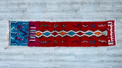Enhance your home with a vintage Moroccan runner rug, handwoven by Berber artisans for authentic tribal charm. This 2x10 ft hallway runner features intricate geometric patterns and a distressed, bohemian aesthetic, perfect for entryways, kitchens, or living spaces. Made from natural wool, this Azilal or Boujad-style rug showcases earthy tones and faded hues, adding warmth to any decor. Each piece is unique, with slight imperfections that highlight its handmade heritage. Ideal for boho, rustic, or eclectic i