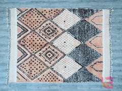 Add a touch of global sophistication with this vintage Moroccan tribal rug, meticulously handmade from premium wool. Inspired by Berber nomadic designs, this Beni Ourain-style carpet features abstract diamond patterns and a plush, high-pile texture for ultimate comfort. The neutral cream and black tones create a calming, organic feel, perfect for Scandinavian, boho, or eclectic interiors. Each rug is one-of-a-kind, with slight variations that highlight its artisan-crafted authenticity. Ideal for living room