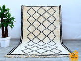 Elevate your home with this genuine vintage Berber rug, showcasing intricate tribal motifs and organic wool craftsmanship. Each piece tells a story through its unique patterns, reflecting centuries-old weaving traditions. The neutral tones and distressed finish create a rustic yet refined look, perfect for adding texture to minimalist or eclectic spaces. Whether layered over hardwood floors or paired with modern furniture, this Moroccan boujad rug brings warmth and cultural charm. Hand-knotted with premium