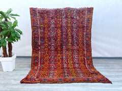 Enhance your décor with this stunning antique wool rug, featuring bold tribal motifs and a luxurious handmade feel. Woven using age-old techniques, this piece boasts a soft, high-pile texture and a captivating mix of natural dyes, creating a harmonious blend of colors. The intricate patterns, inspired by traditional nomadic designs, add depth and movement to any room. Whether placed in a modern loft, a cozy bungalow, or a global-inspired retreat, this rug effortlessly infuses warmth and sophistication. Its 