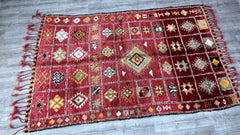 Bring old-world charm into your home with this antique Moroccan tribal rug, handcrafted by Berber weavers. This 6x12 ft vintage carpet features a Boujad-inspired design, with soft wool fibers, faded hues, and traditional geometric patterns that exude warmth and character. Perfect for layering in boho, eclectic, or minimalist interiors, this handmade rug adds depth and cultural authenticity to any room. Its durable construction ensures longevity, while the slightly distressed look enhances its vintage appeal
