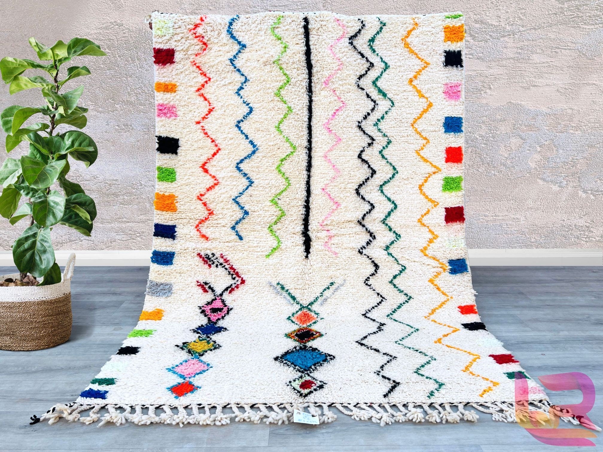 Elevate your home with this handmade Beni Ourain-style rug, inspired by the iconic tribal designs of Morocco. Woven from premium natural wool, this vintage Berber rug features a plush texture and minimalist geometric motifs, perfect for adding warmth to any room. The neutral tones complement both contemporary and traditional interiors, making it a versatile choice for living rooms, dining areas, or bedrooms. Each rug is one-of-a-kind, showcasing the artisan’s craftsmanship and cultural heritage. Durable, co