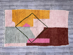 Discover the artistry of Moroccan weaving with this stunning Boujaad rug in vibrant pink and orange. Measuring 9'5x6'5 ft (2.9x2 m), this hand-knotted wool rug features the signature Bidouh pattern, a hallmark of Berber craftsmanship. The rich, warm tones and abstract geometric designs make it a focal point for any room, whether styled in boho, mid-century, or eclectic decor. Made from premium sheep wool, it offers softness, durability, and insulation, perfect for high-traffic areas. Each rug is one-of-a-ki