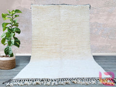 Bring timeless elegance into your home with this authentic Beni Ourain Moroccan rug, handcrafted by skilled artisans. Measuring 8.5 FT x 11.7 FT (approx. 8x12), this fluffy, plush rug features the iconic geometric black-and-white designs of the Beni Ourain tribe, made from 100% natural wool. Each rug is hand-knotted, ensuring durability and a unique texture. Perfect for living rooms, bedrooms, or cozy spaces, this Moroccan shag rug adds warmth, texture, and a touch of bohemian luxury. The soft, high-pile wo