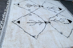 Elevate your home décor with a handmade Berber rug, crafted using traditional techniques passed down through generations. This authentic Moroccan rug features genuine lamb wool, offering unmatched softness and durability. The Beni Ourain-inspired design blends minimalist elegance with tribal charm, making it a perfect addition to modern and boho interiors. Each piece is hand-knotted by skilled artisans, ensuring a unique, high-quality finish. Whether you prefer a custom size or a classic pattern, this luxur