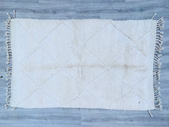 Discover the beauty of authentic handmade Moroccan Beni Ourain rugs, crafted by skilled Berber artisans using premium wool. These luxurious rugs feature a soft, high-pile texture with traditional geometric patterns, adding warmth and elegance to any space. Perfect for living rooms, bedrooms, or hallways, each rug is a unique piece of art, blending bohemian charm with minimalist design. The natural wool fibers provide durability and comfort, making them ideal for cozy interiors. Whether you prefer classic iv