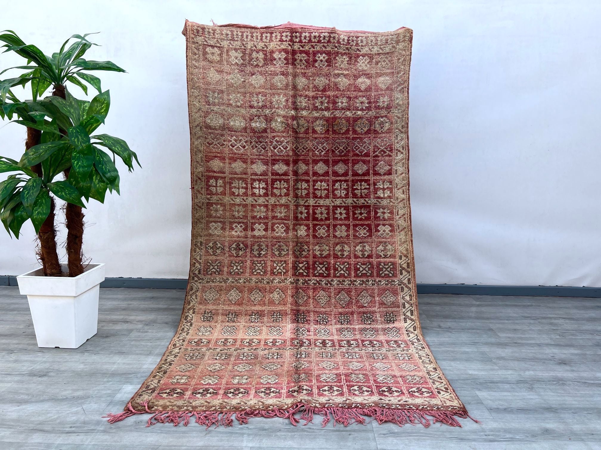 Elevate your décor with this authentic handwoven Moroccan rug, featuring a striking vintage tribal design. The intricate geometric motifs and warm color palette reflect traditional Berber artistry, blending seamlessly with contemporary, bohemian, or rustic interiors. Made from natural wool, this handmade area rug is soft yet durable, perfect for high-traffic spaces. Whether placed in a living room, dining area, or bedroom, it adds texture, warmth, and a touch of global elegance. A true statement piece, this