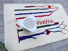 Discover the beauty of authentic Moroccan Azilal rugs, meticulously handwoven by Berber artisans using natural wool. These unique rugs feature vibrant colors, intricate geometric patterns, and a plush texture, making them a perfect addition to bohemian, modern, or traditional interiors. Each piece tells a story through its abstract designs, reflecting centuries-old craftsmanship. Ideal for living rooms, bedrooms, or as statement floor art, these rugs bring warmth and cultural charm to any space. Ethically s