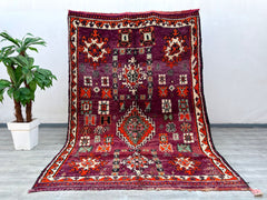 Discover the timeless beauty of this vintage Moroccan Berber rug, a handmade wool masterpiece featuring intricate tribal patterns and natural dyes. With dimensions of 7x14 feet, this oversized area rug is ideal for open-concept spaces, dining rooms, or cozy lounges. The Boujaad design reflects Moroccan craftsmanship, blending vintage aesthetics with durable, soft wool for long-lasting comfort. Each rug tells a story through its unique geometric motifs, making it a conversation-starting centerpiece. Whether 