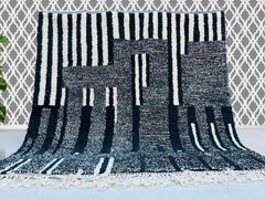 Discover the timeless beauty of authentic Moroccan Berber rugs, handwoven by skilled artisans using genuine wool for durability and softness. Our collection features custom Moroccan rugs, including Beni Ourain, Azilal, and minimalist designs, perfect for adding a touch of tribal elegance to any space. Each handmade rug showcases unique geometric patterns in black and white, neutral tones, or vibrant colors, making them ideal area rugs for living rooms, bedrooms, or offices. Whether you prefer a traditional 