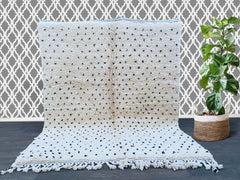 Moroccan Beni Ourain wool carpet to measure a sublime Berber rug crafted entirely by hand that gives your home the authentic vintage stamp. Made from 100% pure virgin wool, this beautiful rug brings a little bit of boho chic to your home. Skilled artisans hand-weave each piece that represents a unique and quality-made design. Great for living rooms, bedrooms or that cozy reading nook; this versatile rug is not only a warming and comforting piece but a visually stunning one too that can be played up as the