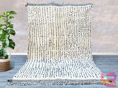 Boujad Moroccan Rug, meticulously handmade by skilled Berber artisans from the Atlas Mountains. This exquisite piece features unique abstract designs that reflect the rich cultural heritage of Morocco, adding a touch of vibrancy to any room. Crafted from the finest quality wool, each rug is individually spun, dyed using natural products, and woven entirely by hand—ensuring that no machines are involved in the process. Once complete, the rug is trimmed, washed, and sun-dried in the mountain air, resulting in