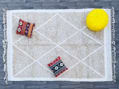 Elevate your home with this stunning bohemian Azilal rug, hand-knotted using premium wool for a plush, cozy feel. Featuring vibrant tribal motifs and a unique distressed look, this rug adds character and charm to any room. Whether placed in a modern, rustic, or eclectic setting, its artistic patterns create a focal point that enhances your decor. The natural wool fibers provide durability and comfort underfoot, making it ideal for high-traffic areas. A beautiful blend of tradition and contemporary style, th