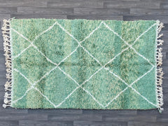 Add a touch of bohemian flair with this luxurious green shaggy Moroccan rug, hand-knotted from pure wool for a plush, inviting feel. The high-pile texture and organic patterns create a cozy, layered look, perfect for living rooms, bedrooms, or reading nooks. The rich green palette enhances both neutral and vibrant interiors, while the handmade craftsmanship ensures a one-of-a-kind piece. Durable and naturally insulating, this rug is ideal for adding comfort and style to your home. Its timeless design works 