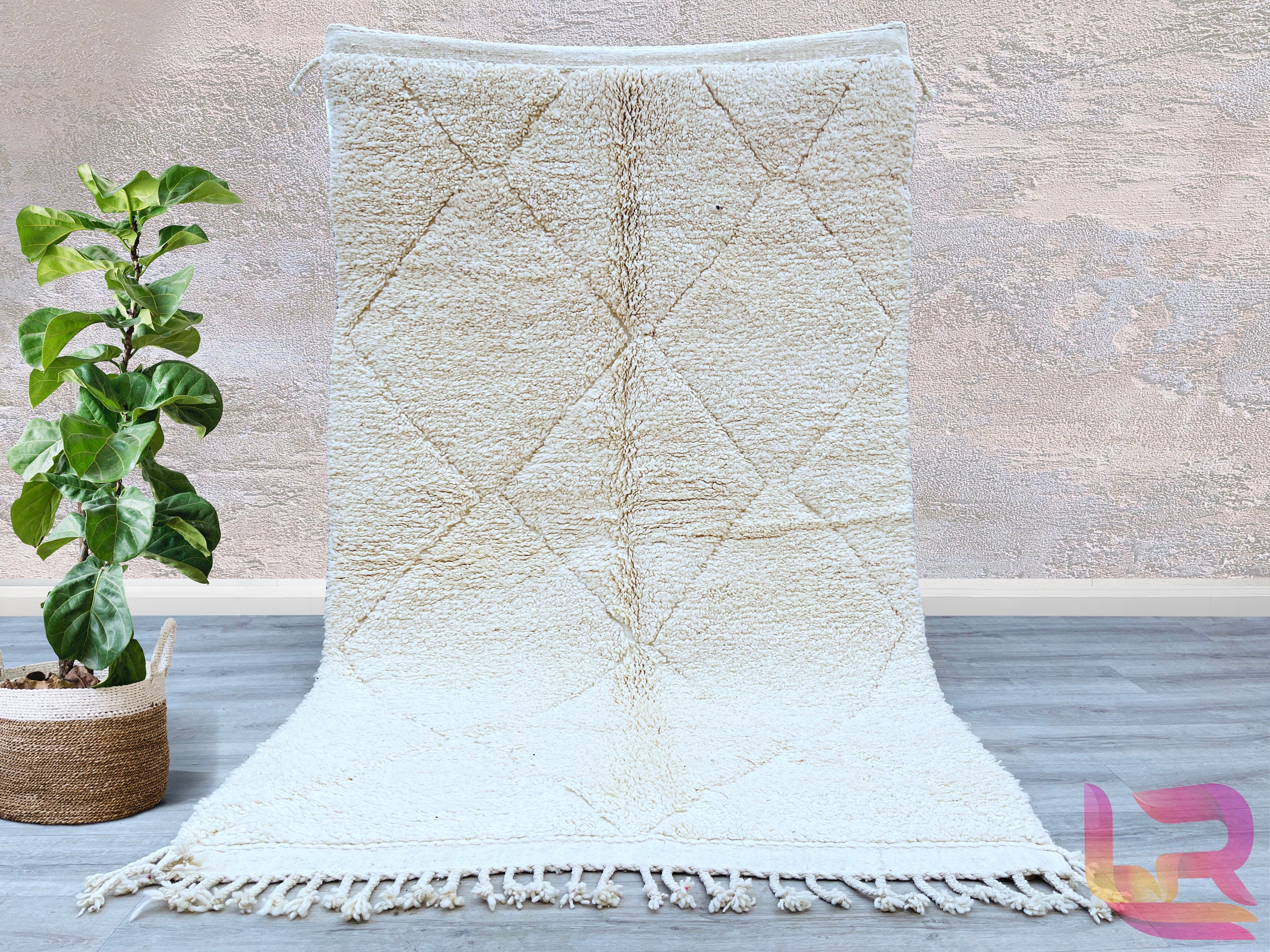 Elevate your home décor with a stunning Moroccan Berber rug, handwoven by artisans using traditional techniques. These rugs showcase intricate tribal patterns and a plush wool texture, offering both style and comfort. The neutral tones and geometric designs effortlessly complement boho, Scandinavian, or contemporary interiors. Each rug is sustainably crafted, ensuring a unique, eco-friendly addition to your space. Whether used as a statement piece in the living room or a cozy accent in the bedroom, these ru