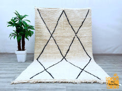 Enhance your space with a bohemian Moroccan rug, featuring intricate Berber designs and plush wool craftsmanship. This hand-knotted vintage carpet showcases tribal patterns that tell a story of Moroccan heritage, adding a touch of global charm to your home. The soft, thick pile provides luxurious comfort, while the neutral tones effortlessly complement Scandinavian, eclectic, or minimalist styles. Perfect as a statement piece in the living room, bedroom, or dining area, this eco-friendly wool rug is both du