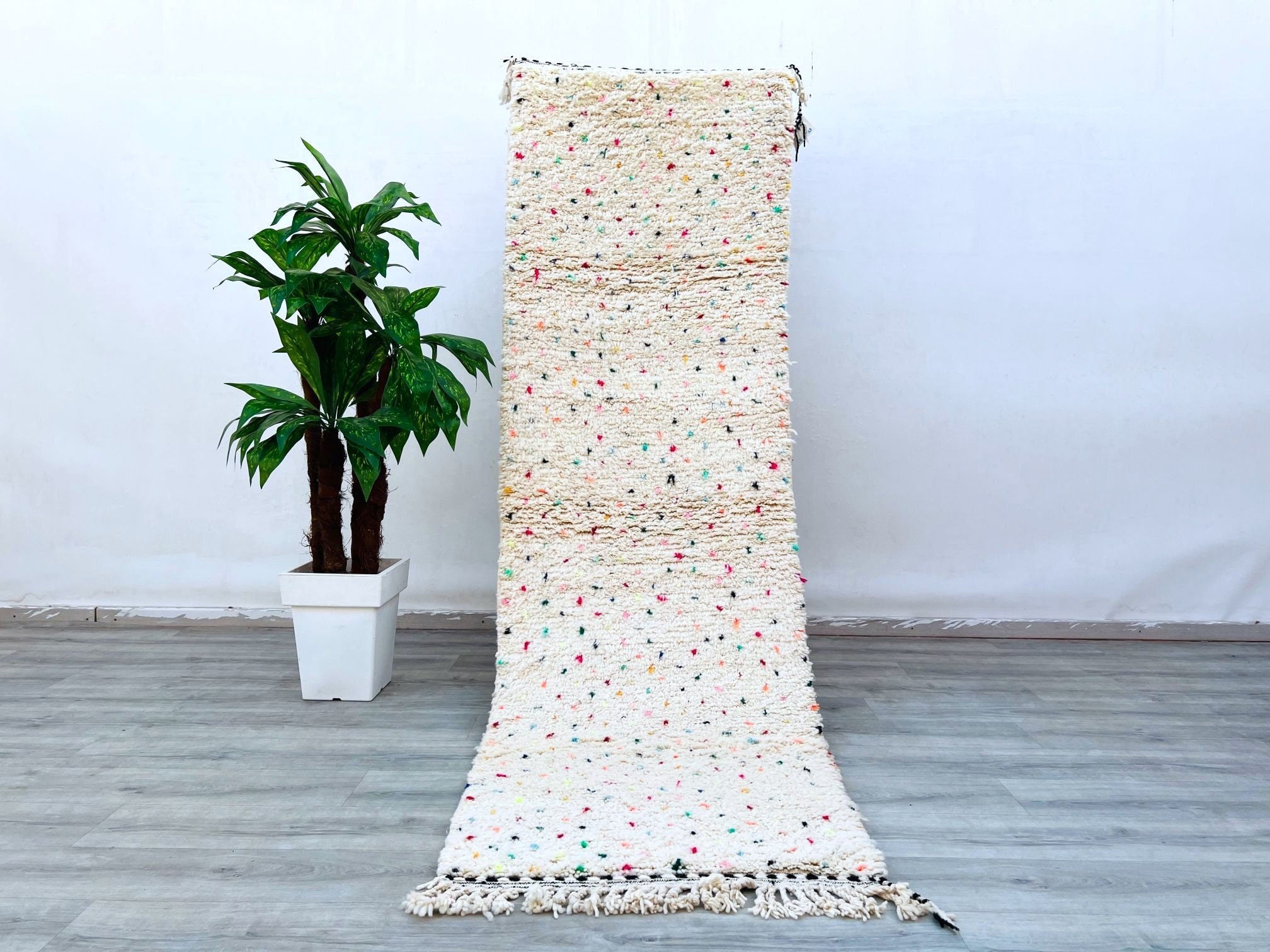 This large Moroccan Kilim Rug is a stunning combination of form and function. Handcrafted from traditional wool, it features a vintage Kilim design with vibrant colors and intricate patterns. Use it as an ottoman, or decorative piece to enhance your 