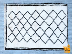 Indulge in luxury with this ultra-soft, shaggy Moroccan-inspired rug, designed for both comfort and style. Featuring a plush high-pile texture and a subtle diamond trellis pattern, this piece adds a touch of bohemian elegance to any space. The neutral ivory and charcoal tones effortlessly complement modern, coastal, or farmhouse interiors. Perfect for cozying up living rooms, bedrooms, or nurseries, this hand-loomed rug is both durable and easy to maintain. Its versatile design ensures it blends seamlessly 