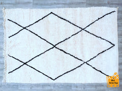Create a personalized touch with a custom wool Berber rug, meticulously handwoven by Moroccan artisans. Designed for modern and traditional interiors, this versatile area rug features organic textures and subtle geometric patterns, making it a timeless addition to any room. The breathable natural wool ensures softness and warmth, while the durable construction withstands daily wear. Whether you need a neutral floor accent or a boho-chic statement piece, this handmade Moroccan carpet elevates your space with