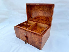 Enhance your jewelry collection with this stunning handcrafted wooden jewelry box, meticulously made from luxurious Thuya burl wood. Featuring a two-level storage design, this Moroccan-inspired box offers ample space for rings, necklaces, watches, and other precious accessories. The mirror inside the lid adds a functional touch, while the secure lock and key ensure your valuables stay protected. Each piece showcases the natural beauty of burl wood grain, making it a unique decorative keepsake. Perfect as an