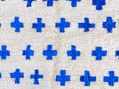 Shop authentic Moroccan wool rugs in blue and white, handwoven by fair trade cooperatives like The Anou. These Beni Ourain, checkered, and Azilal rugs are pet-friendly, hypoallergenic, and customizable (8x10 ft, 6x9 ft, etc.). Ideal for boho, Scandinavian, or eclectic interiors, each piece features tribal symbols, crosses, or checkerboard patterns. Available on Etsy, eBay, and boutique sites, these rugs are durable, stain-resistant, and ethically sourced. Whether for bedrooms, hallways, or living rooms, the